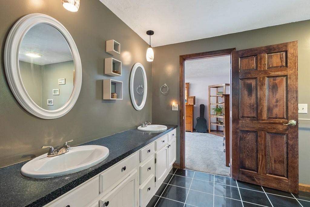 63 Russell Hill Road Ashburnham, MA 01430 - Photo 20 of 30 a spacious bathroom with a double vanity sink and a mirror