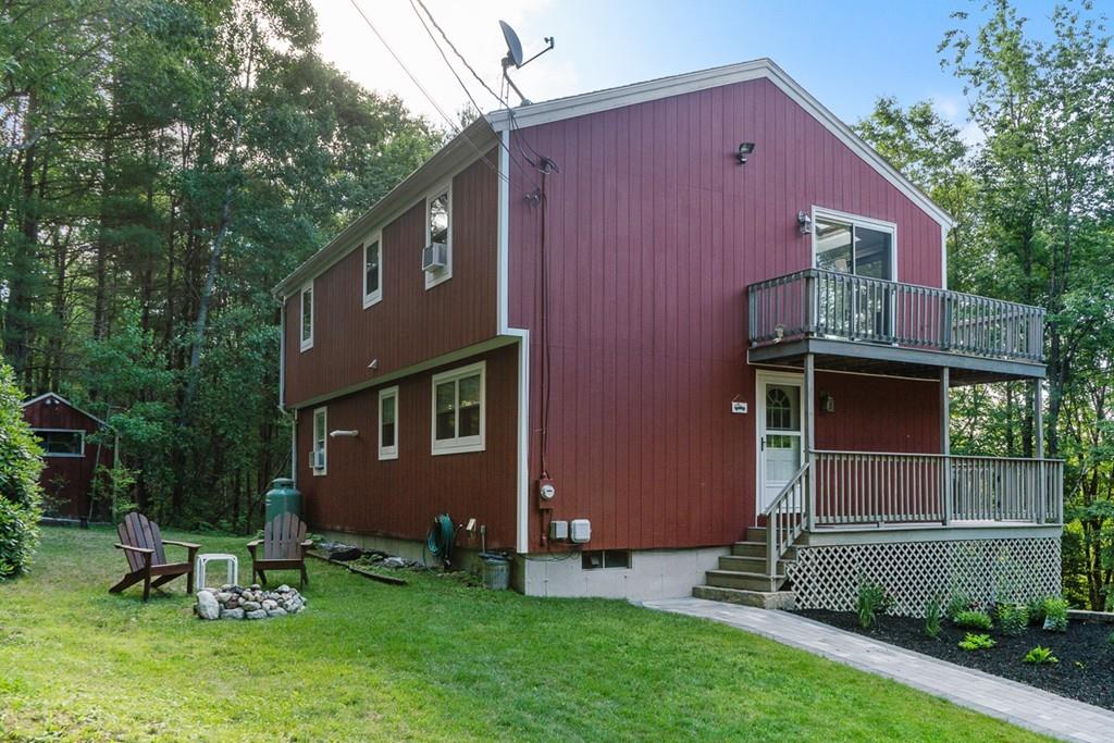 63 Russell Hill Road Ashburnham, MA 01430 - Photo 2 of 30 a front view of a house with a garden