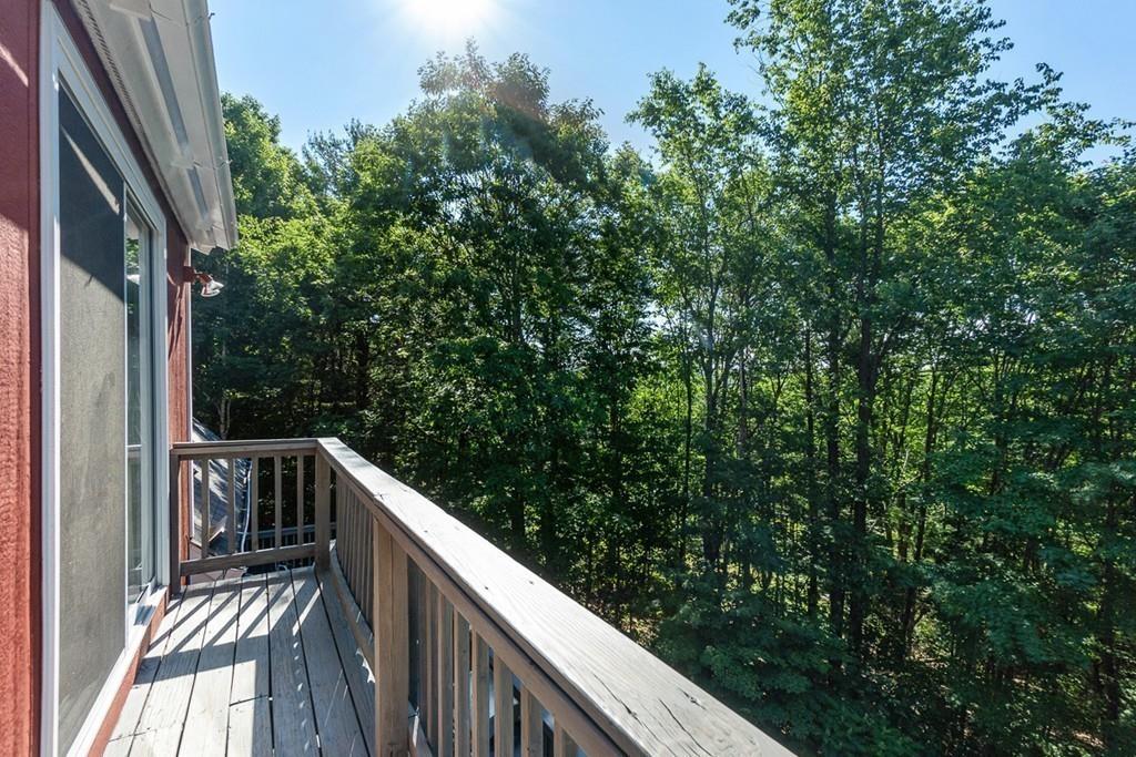 63 Russell Hill Road Ashburnham, MA 01430 - Photo 26 of 30 a balcony with wooden floor and yard in the back