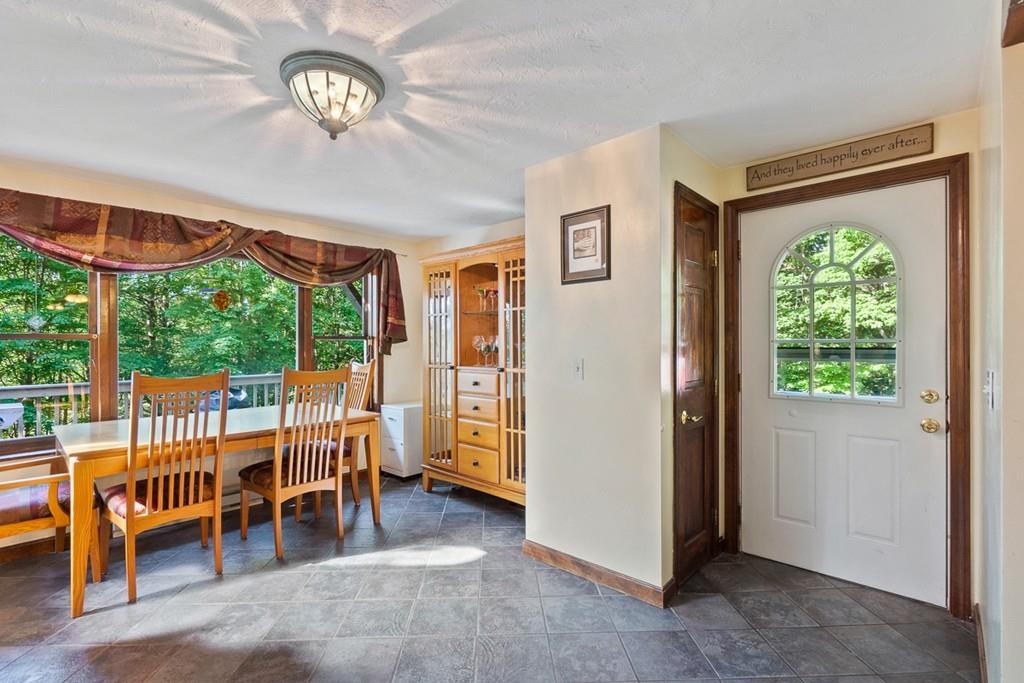 63 Russell Hill Road Ashburnham, MA 01430 - Photo 6 of 30 a view of a big room with furniture and a large window