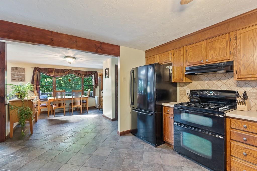 63 Russell Hill Road Ashburnham, MA 01430 - Photo 8 of 30 a kitchen with granite countertop a refrigerator and a stove top oven