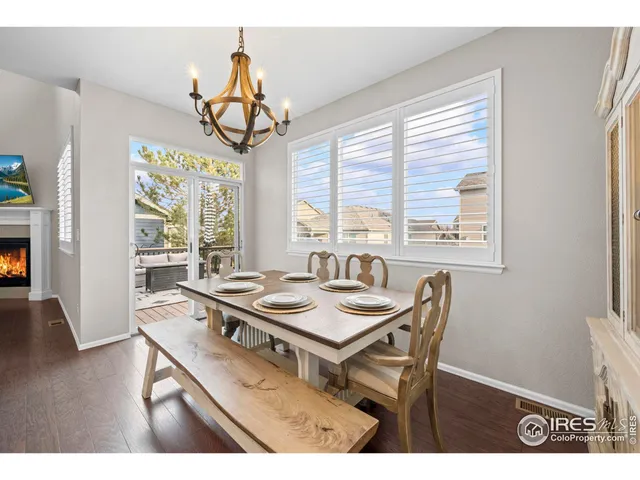 a view of a dining room with furniture wooden floor and a chandelier