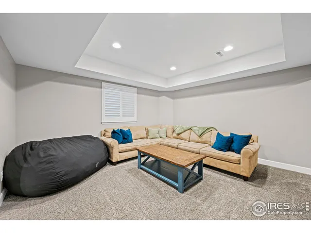 a living room with furniture a window and a projector