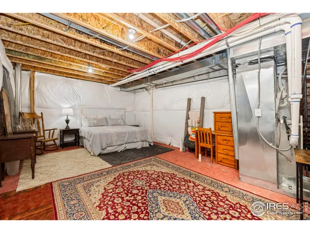 a bed room with a bed and a chair