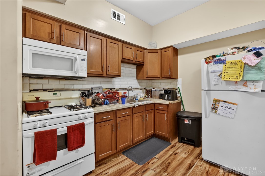 7045-7049 Montgomery Road Cincinnati, OH 45236 - Photo 50 of 68 This cozy kitchen offers essential appliances and ample cabinetry, ready for your culinary endeavors.