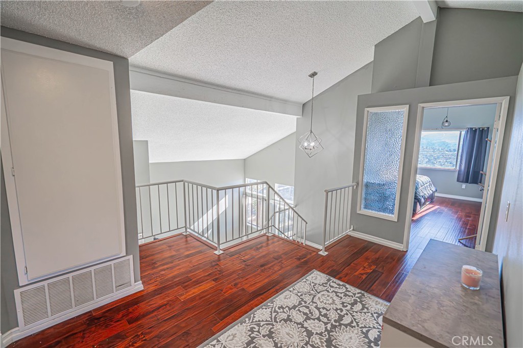 28076 Wildwind Road Canyon Country, CA 91351 - Photo 19 of 48 a bedroom with furniture and wooden floor