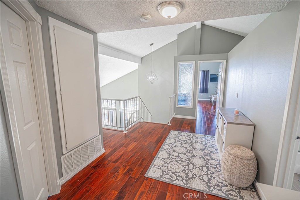 28076 Wildwind Road Canyon Country, CA 91351 - Photo 21 of 48 a view of a hallway with wooden floor and furniture