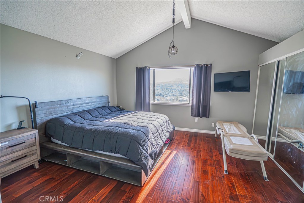 28076 Wildwind Road Canyon Country, CA 91351 - Photo 22 of 48 a bedroom with a bed and wooden floor