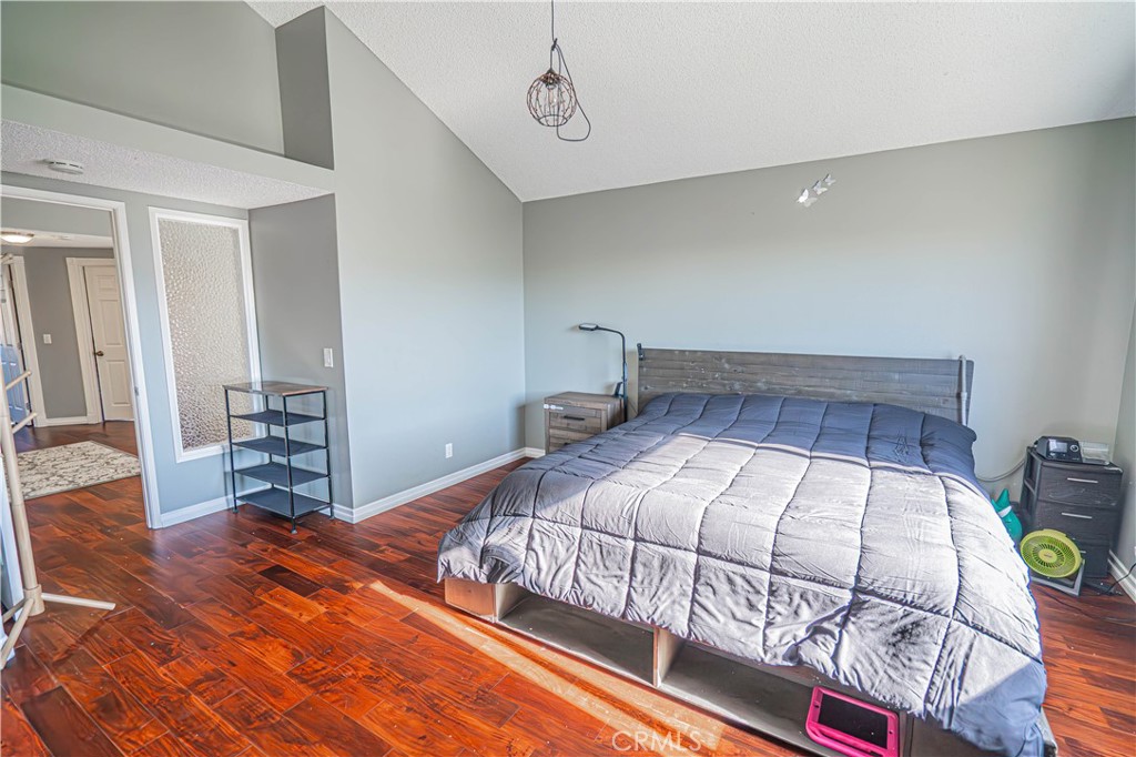 28076 Wildwind Road Canyon Country, CA 91351 - Photo 23 of 48 a bedroom with a bed and wooden floor