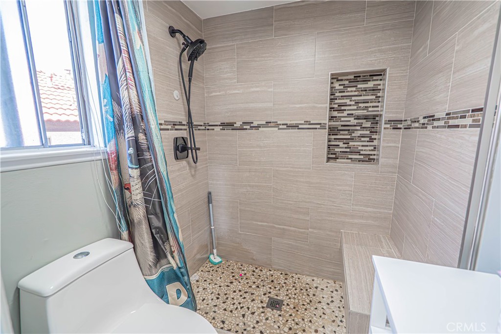 28076 Wildwind Road Canyon Country, CA 91351 - Photo 25 of 48 a bathroom with a shower a toilet and a shower