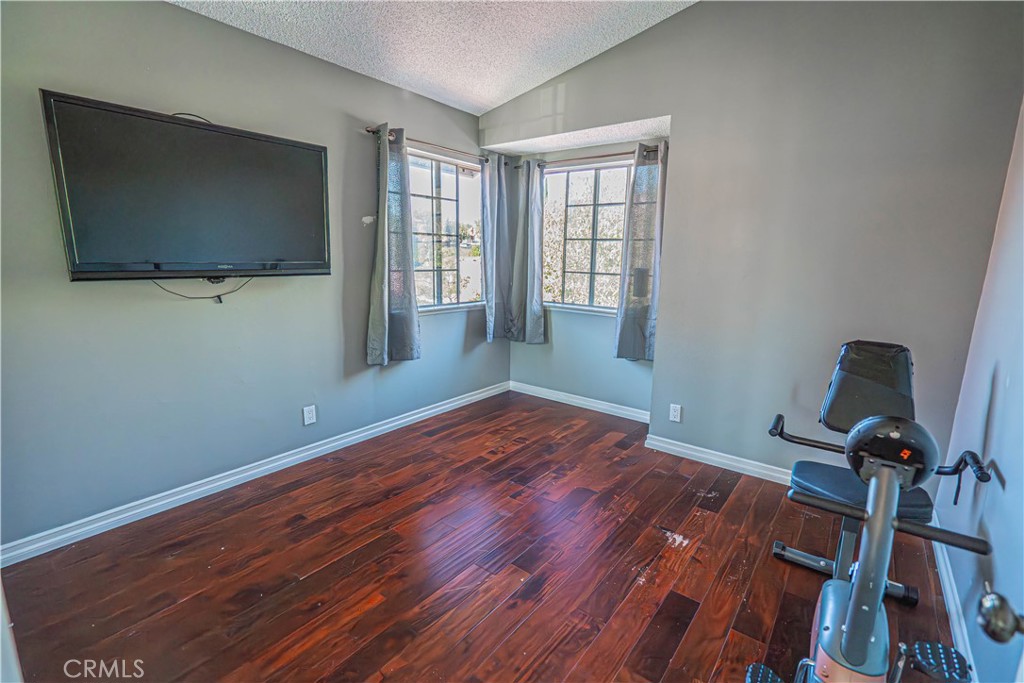 28076 Wildwind Road Canyon Country, CA 91351 - Photo 26 of 48 a view of a room with wooden floor and windows