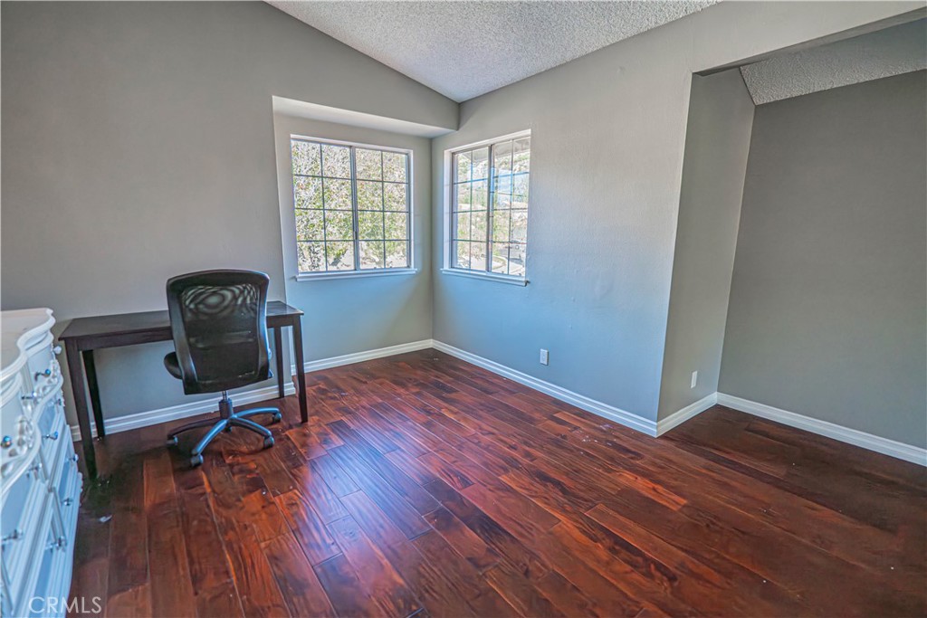 28076 Wildwind Road Canyon Country, CA 91351 - Photo 27 of 48 a view of a workspace with wooden floor and a window