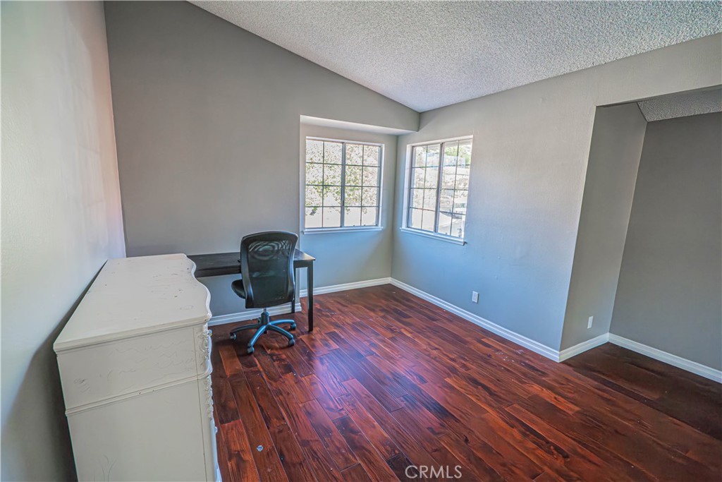 28076 Wildwind Road Canyon Country, CA 91351 - Photo 28 of 48 a workspace with furniture and wooden floor