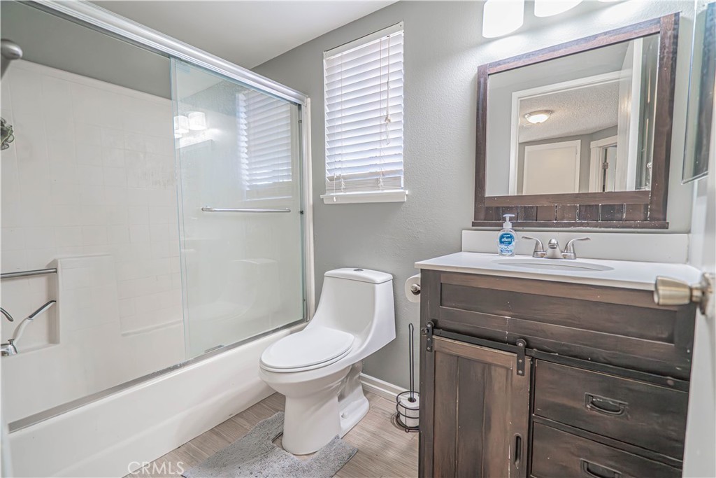 28076 Wildwind Road Canyon Country, CA 91351 - Photo 30 of 48 a bathroom with a toilet sink and mirror