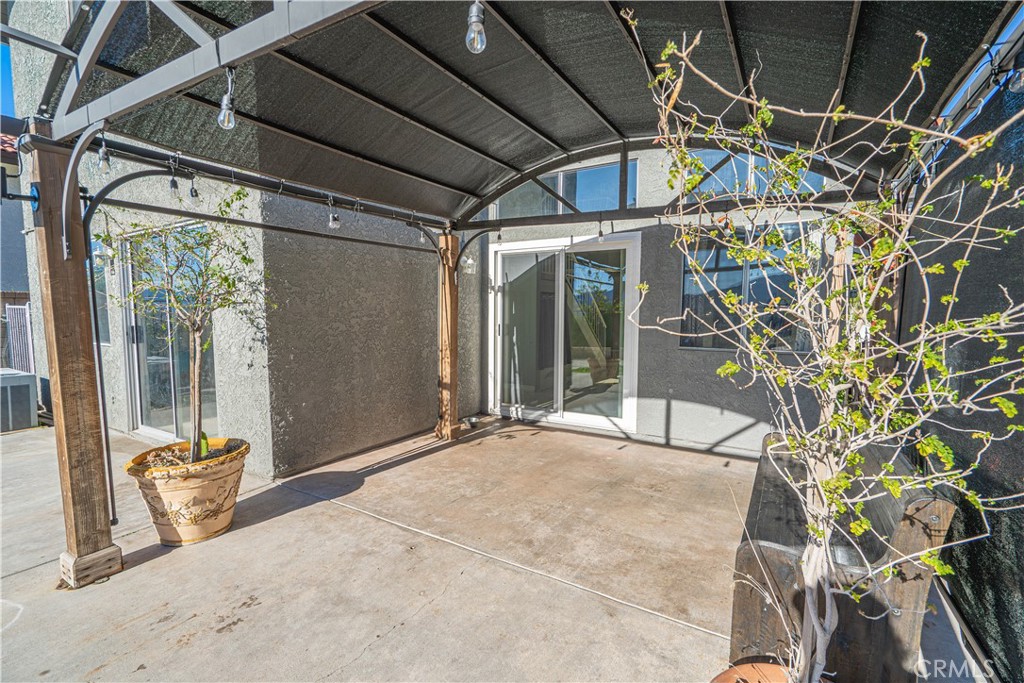 28076 Wildwind Road Canyon Country, CA 91351 - Photo 31 of 48 a view of a patio with table and chairs and potted plants