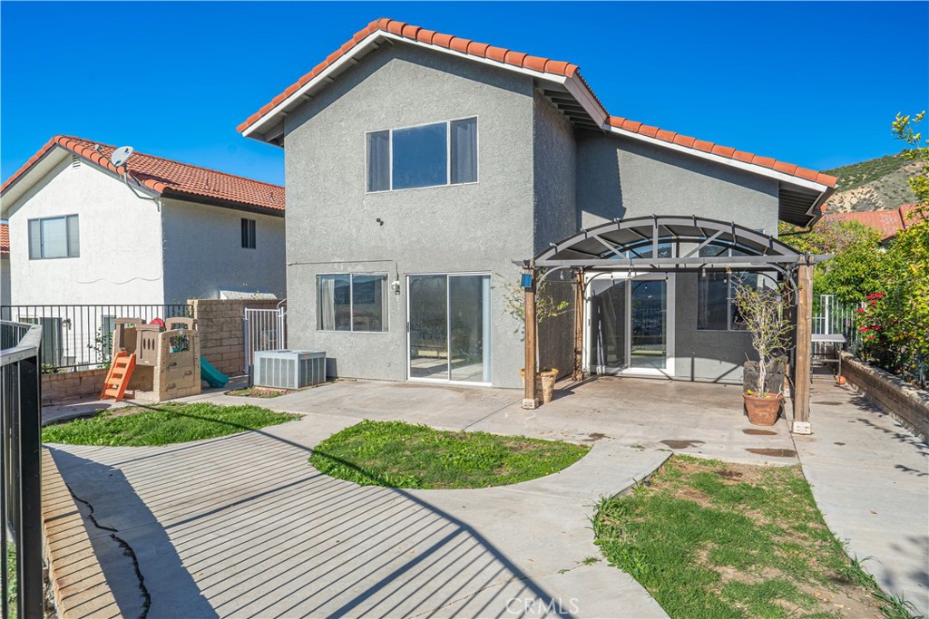 28076 Wildwind Road Canyon Country, CA 91351 - Photo 37 of 48 a front view of a house with a yard and porch