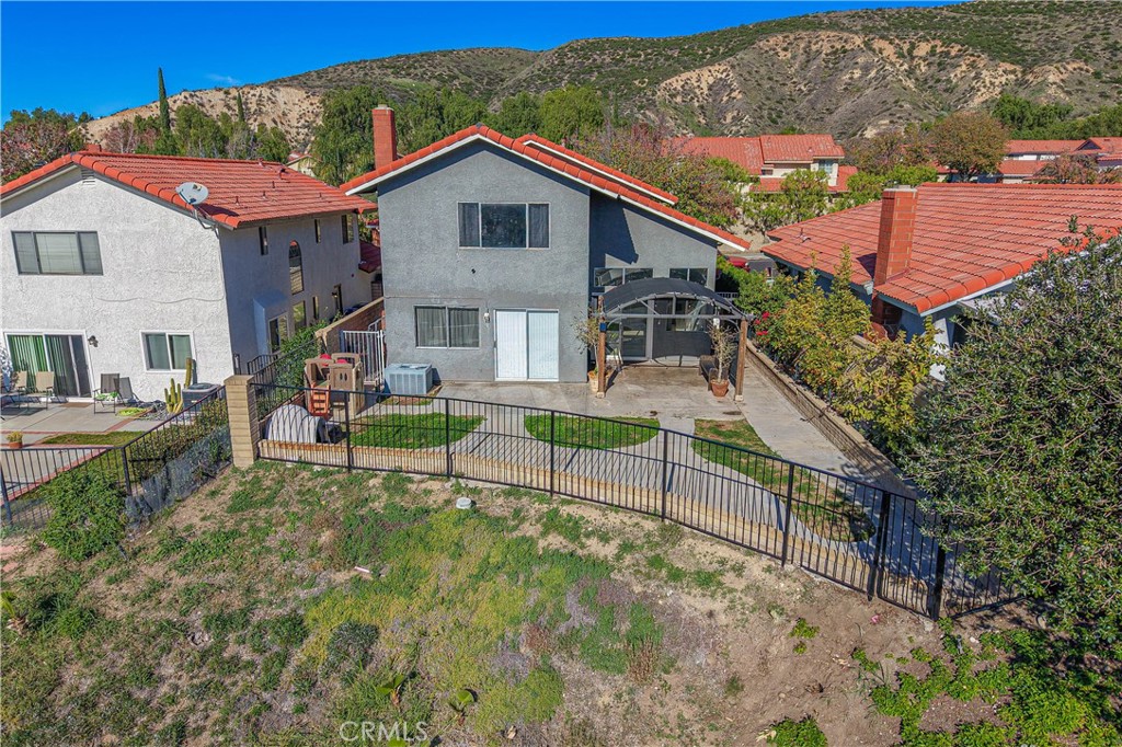 28076 Wildwind Road Canyon Country, CA 91351 - Photo 38 of 48 a view of a house with a yard balcony and furniture