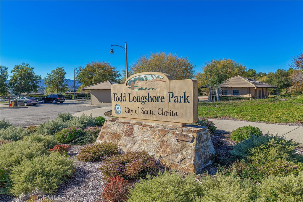 28076 Wildwind Road Canyon Country, CA 91351 - Photo 47 of 48 a sign of golf club on a wall under a blue tree