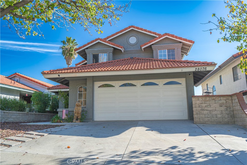 28076 Wildwind Road Canyon Country, CA 91351 - Photo 48 of 48 a front view of a house with a yard and garage