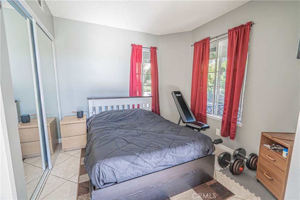 28076 Wildwind Road Canyon Country, CA 91351 - Photo 7 of 48 a bedroom with a bed and a flat screen tv