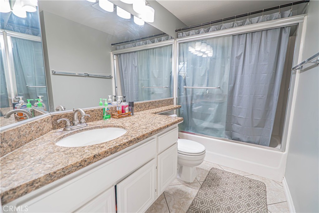 28076 Wildwind Road Canyon Country, CA 91351 - Photo 8 of 48 a bathroom with a granite countertop sink toilet and shower