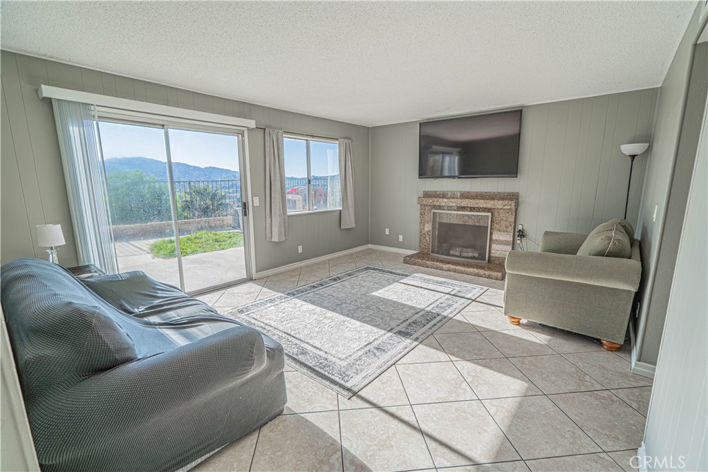 28076 Wildwind Road Canyon Country, CA 91351 - Photo 9 of 48 a living room with a couch and a flat screen tv