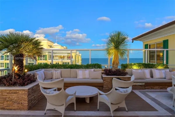 a view of a house with swimming pool and furniture