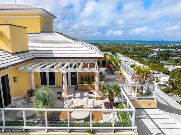 a view of a patio with swimming pool and table and chairs
