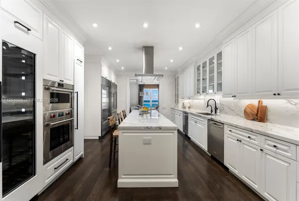 a kitchen with stainless steel appliances kitchen island granite countertop a sink and cabinets