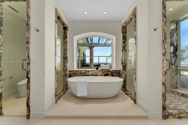 a living room with a large window and a fireplace