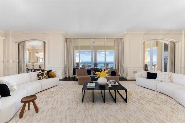 a living room with furniture and floor to ceiling windows