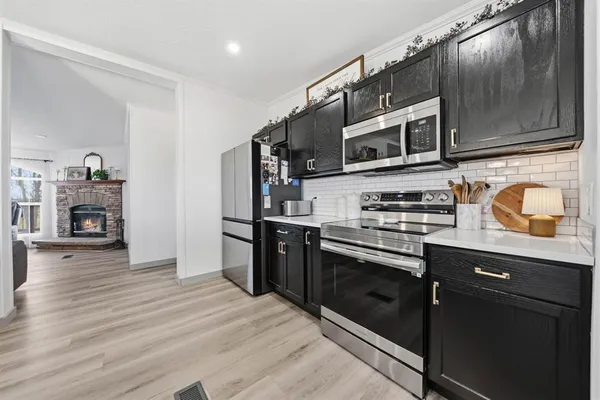 a kitchen with stainless steel appliances granite countertop a stove and a microwave