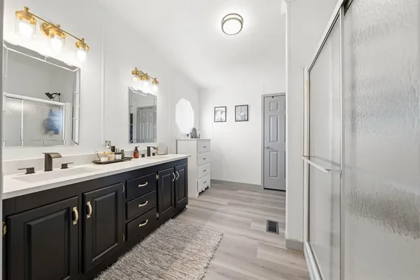 a bathroom with a double vanity sink and mirror