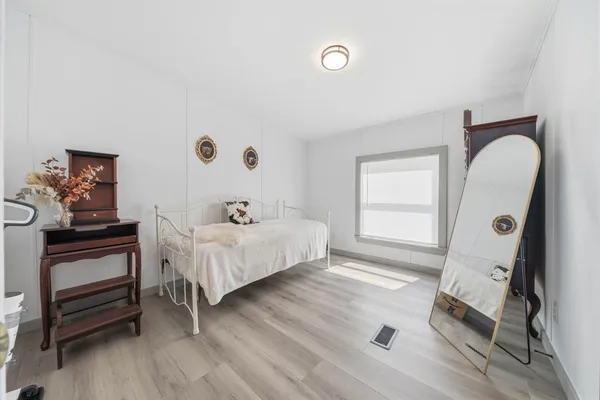 a bed room with a bed and a window