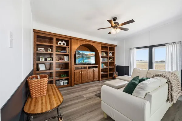 a bedroom with a large bed and a large window