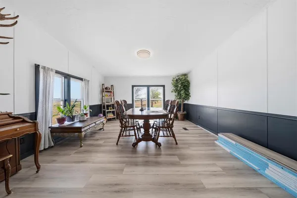 a outdoor dining space with furniture and wooden floor