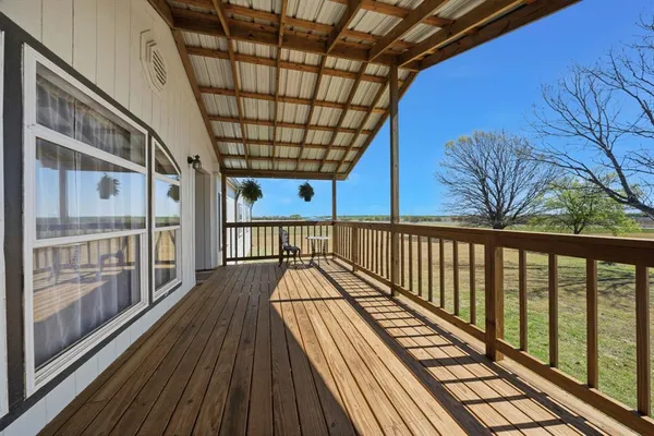 a view of balcony with wooden floor