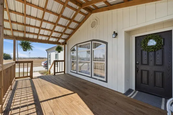 a view of an entryway with wooden floor
