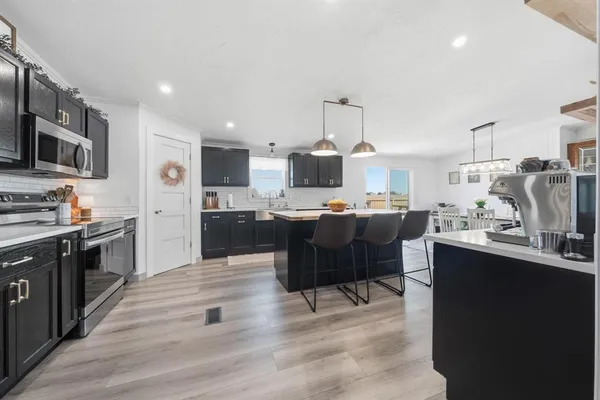 a kitchen with stainless steel appliances kitchen island granite countertop a sink counter space and cabinets