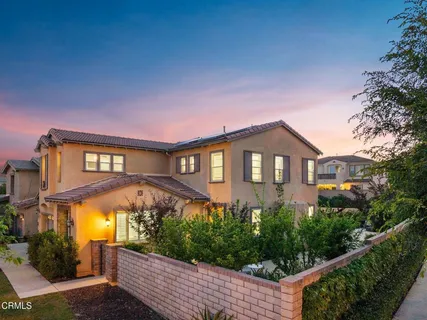 a front view of a house with yard and green space