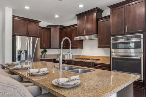 a bathroom with a granite countertop sink a toilet and shower
