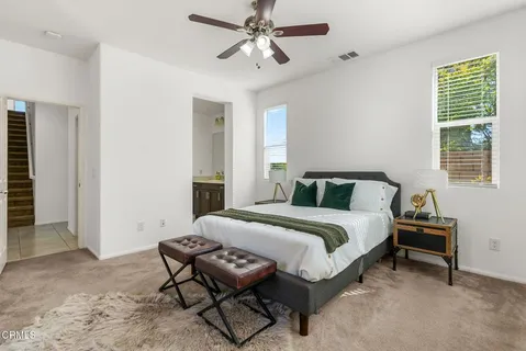 a living room with furniture and a ceiling fan