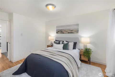 a bedroom with a bed and a potted plant