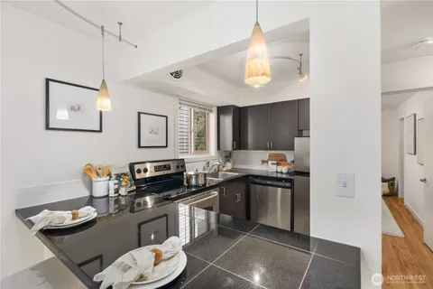 a kitchen with a sink a stove and chairs