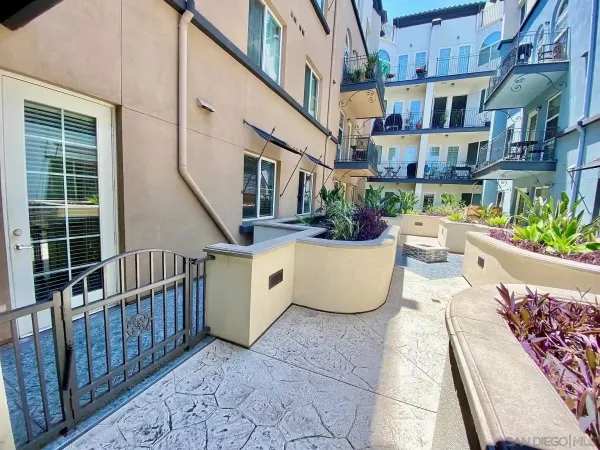a view of a patio with couches table and chairs and potted plants
