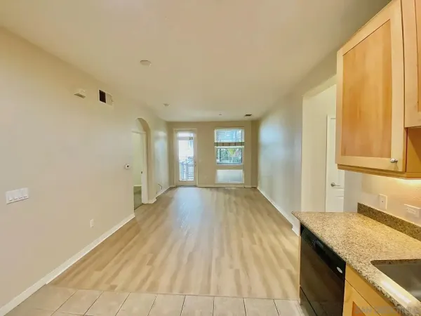 a view of a kitchen with a sink refrigerator and a window