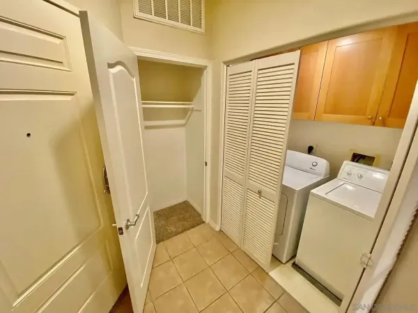 a view of an empty room with window and fire place