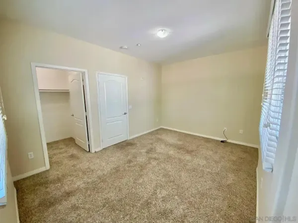 a view of staircase with white walls