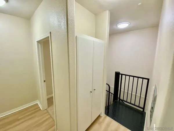 an empty room with windows and closet