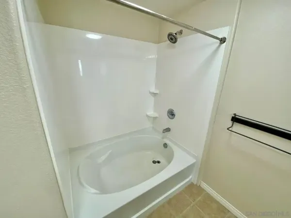 a bathroom with a granite countertop sink a toilet and shower